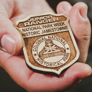 photo of NPS Junior Ranger badge held in a person's hand